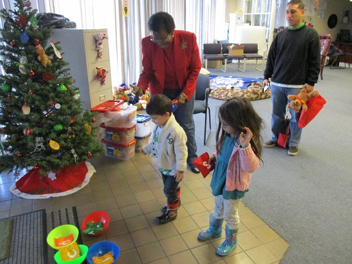 Two children playing ball toss at the Christmas party